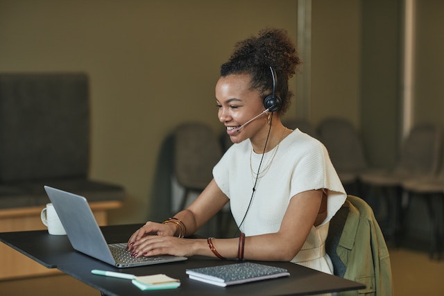 A customer service agent working while smiling